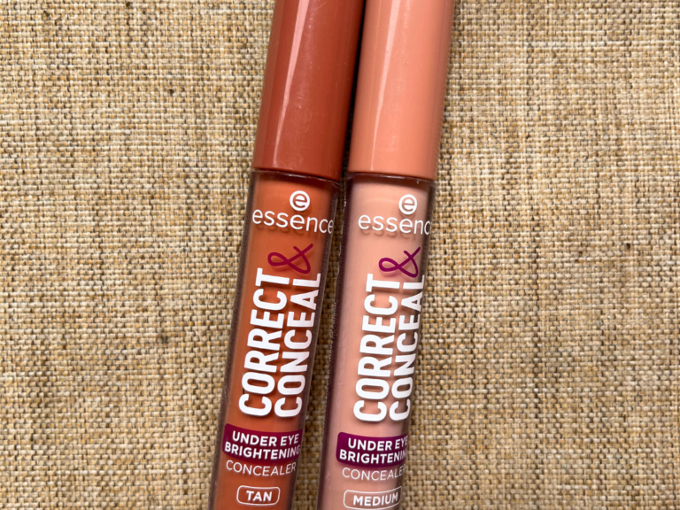 Two Essence Correct & Conceal Under Eye Brightening concealers on a beige textured background