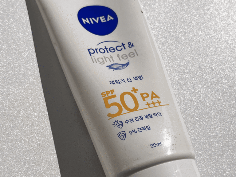 NIVEA Protect & Light Feel Sun Serum SPF 50+ PA+++ photographed in natural sunlight on a clean white background.