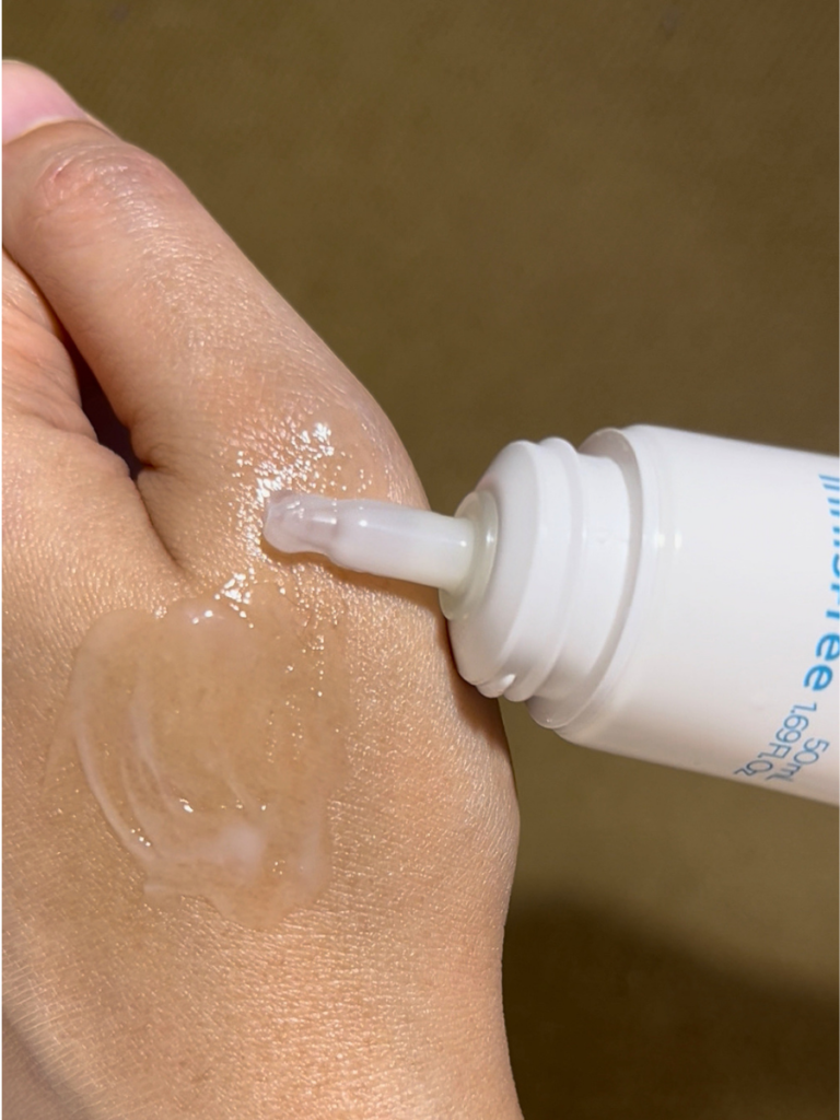 Close-up of the Innisfree Retinol Cica Barrier Cream silicone applicator with cream swatch on the back of the hand.
