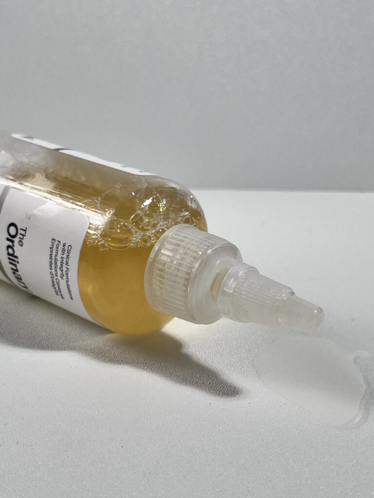Close-up of The Ordinary Glycolic Acid 7% Exfoliating Toner showing the twist-open applicator and light yellow formula inside the bottle.