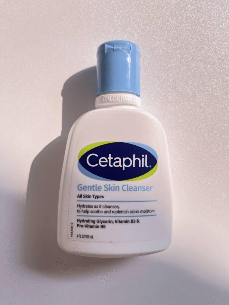 Cetaphil Gentle Skin Cleanser bottle on a white background in natural sunlight. A gentle facial cleanser reviewed for dry and sensitive skin.