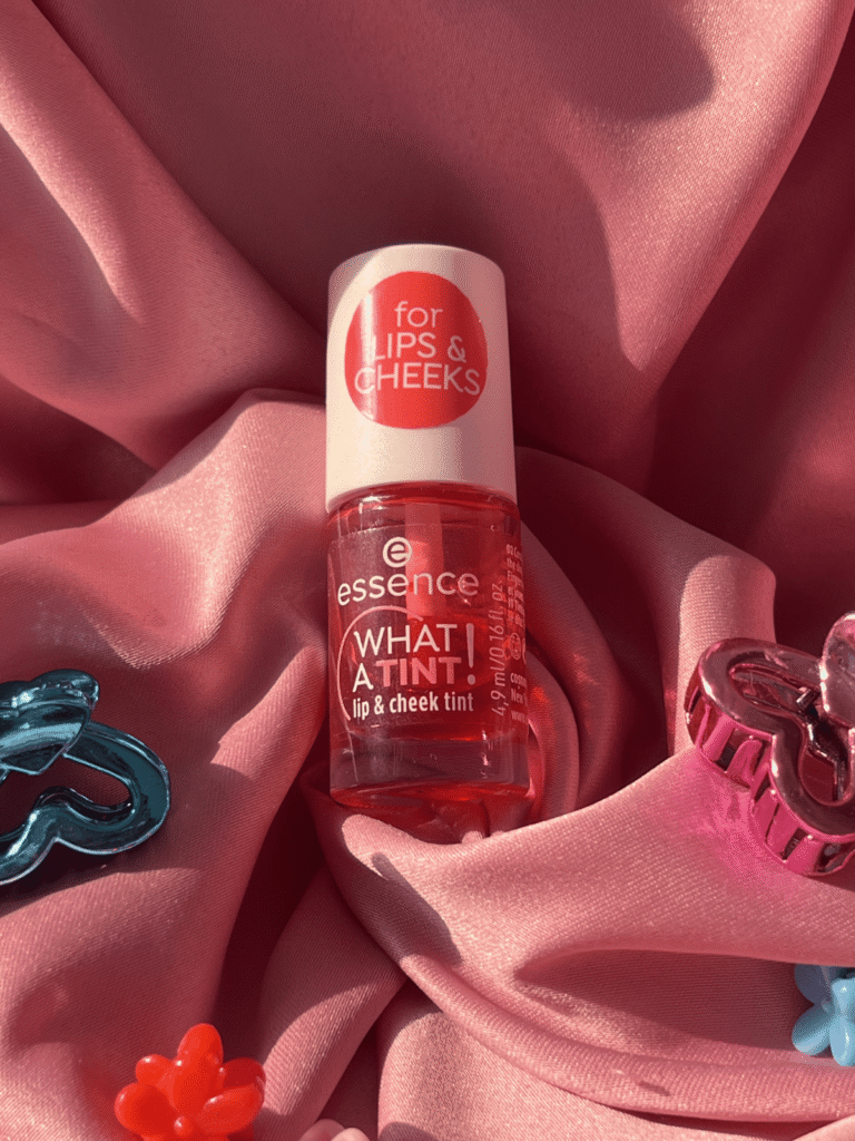 Essence What A Tint Lip and Cheek Tint bottle in shade Coral Sunset